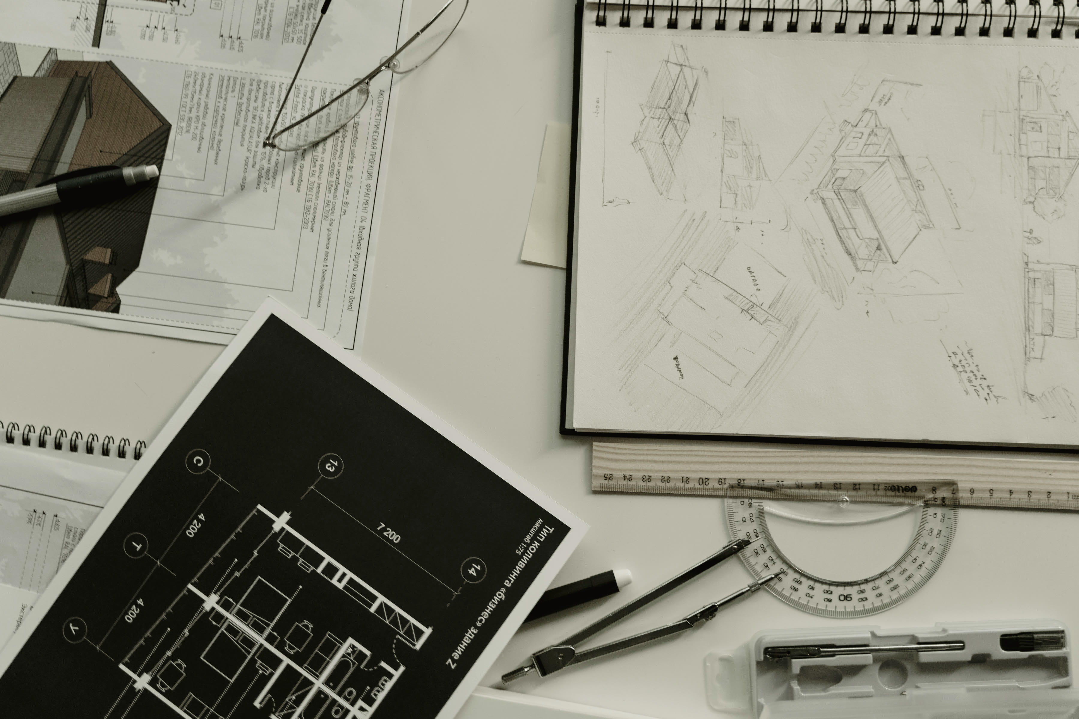 Technical drawings spread across a table on site.