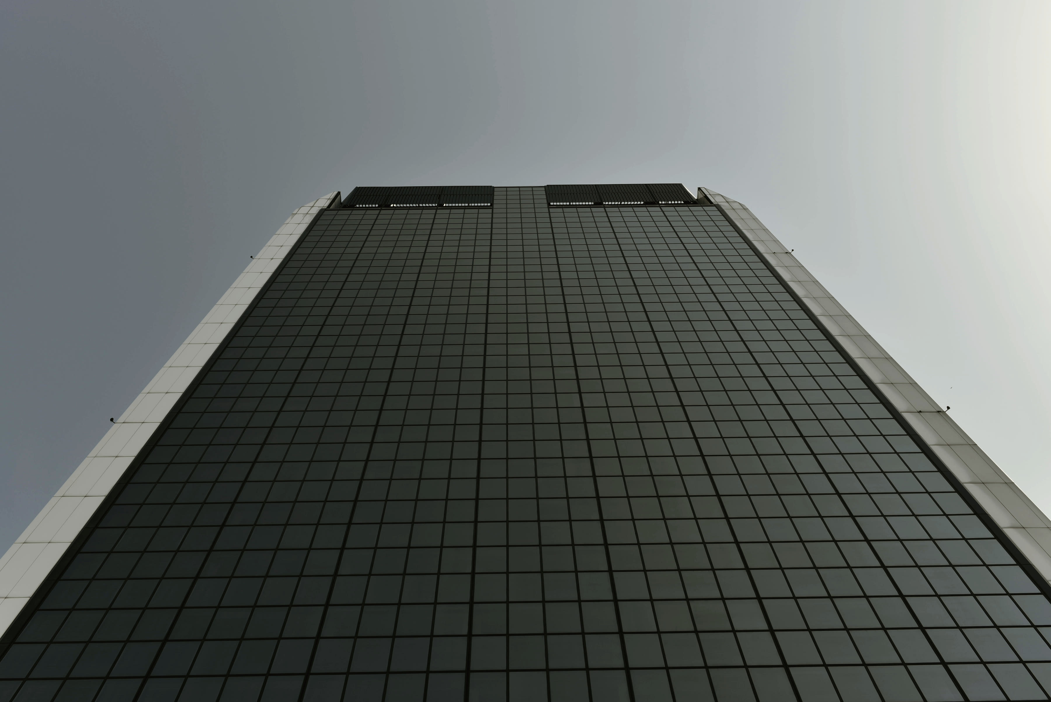 A completed building facade at handover, seen at first light.