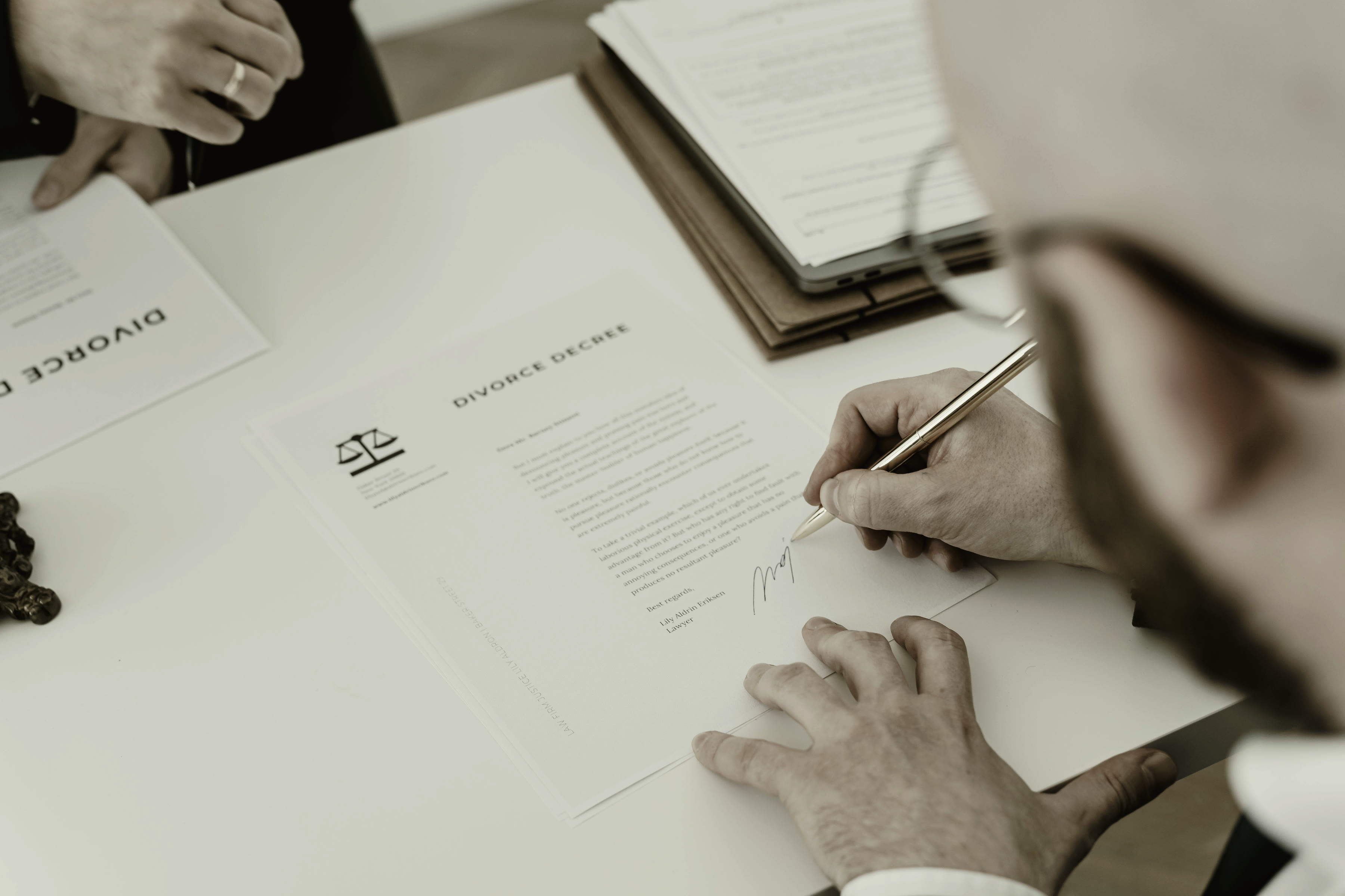 A site office interior at night, paperwork under a single lamp.